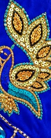 Sequinned peacock motif on royal blue fabric